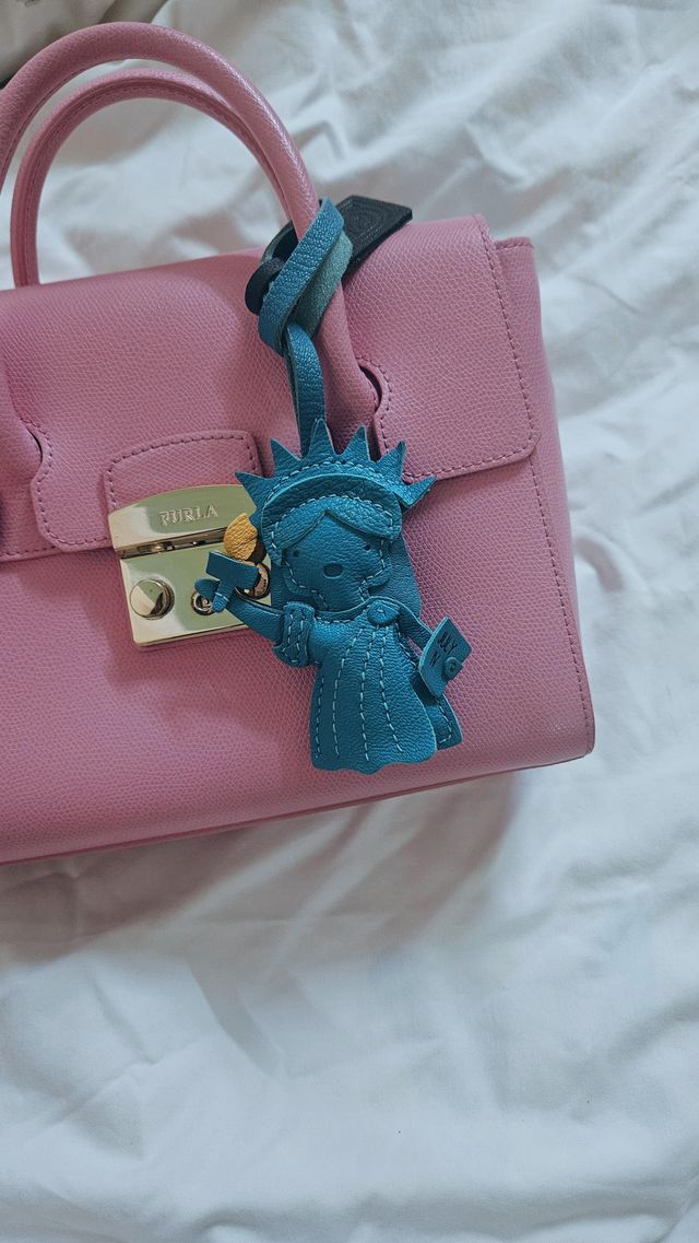 Leather bag charm carried through everyday moments