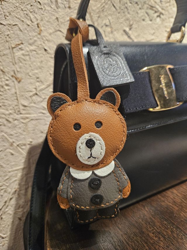 Travel-inspired handcrafted leather bag charm on a handbag