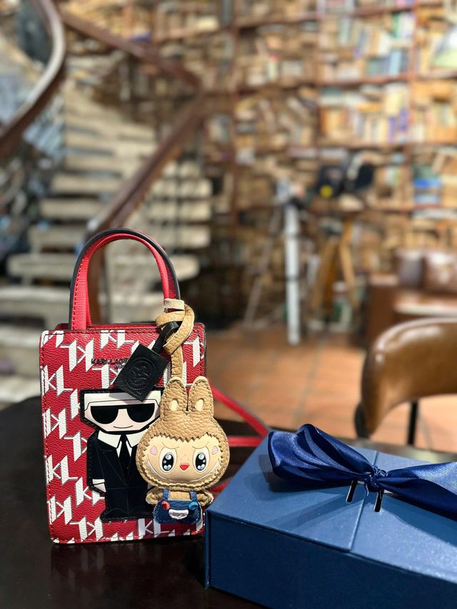 Recipient smiling while carrying a handcrafted leather charm on a favourite handbag
