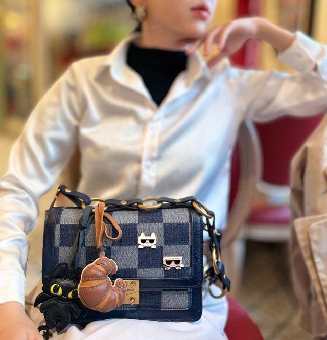 Premium leather bag charm showing natural character after one year of everyday use