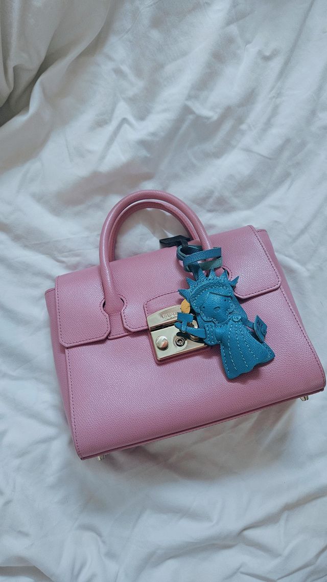 Handcrafted leather bag charm showing beautiful natural aging after regular everyday use
